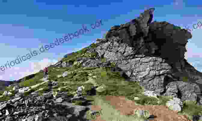 Hikers Scrambling Up The Tourist Route On The Cobbler Classic Mountain Scrambles In Scotland
