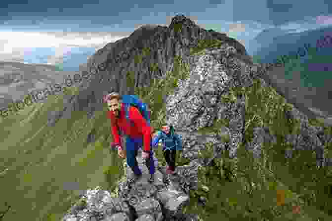 Hikers Traversing The Narrow Ridge Of Aonach Eagach Classic Mountain Scrambles In Scotland
